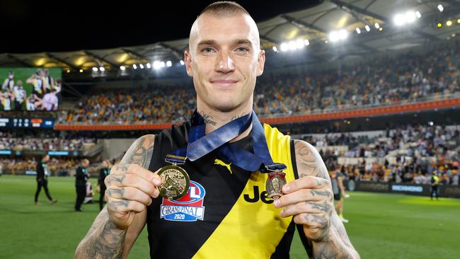 Dustin Martin with his third premiership medal and third Norm Smith Medal.