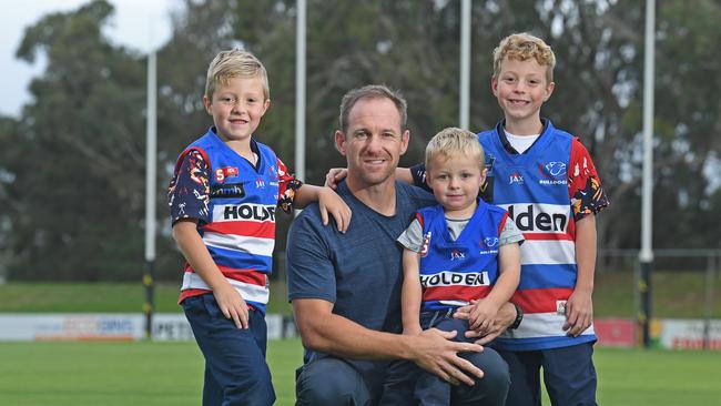 Paul Thomas and his boys Archer, 6, Cohen, 3, and Austin, 8, at Elizabeth Oval. Picture: Tom Huntley