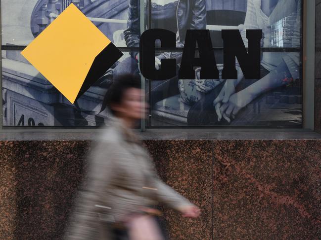 CBD workers walk past the a Commonwealth Bank of Australia branch in Sydney, Monday, June 4, 2018. The CBA has a reached a $700 million dollar settlement over Austrac allegations over anti-money laundering breaches. (AAP Image/Dean Lewins) NO ARCHIVING