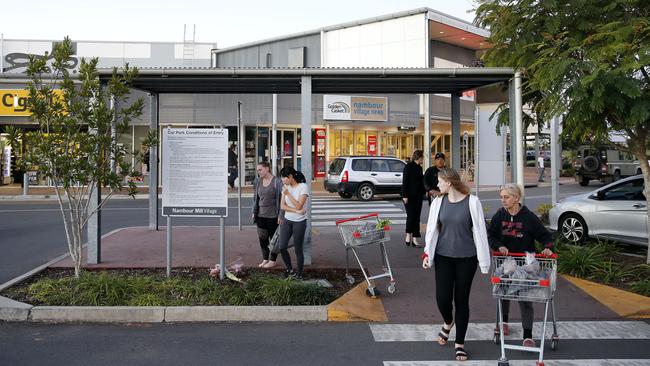 Mourners lay flowers at the scene where a six-year-old girl was killed when a car reversed into a pedestrian crossing.  Picture: AAP Image/Josh Woning