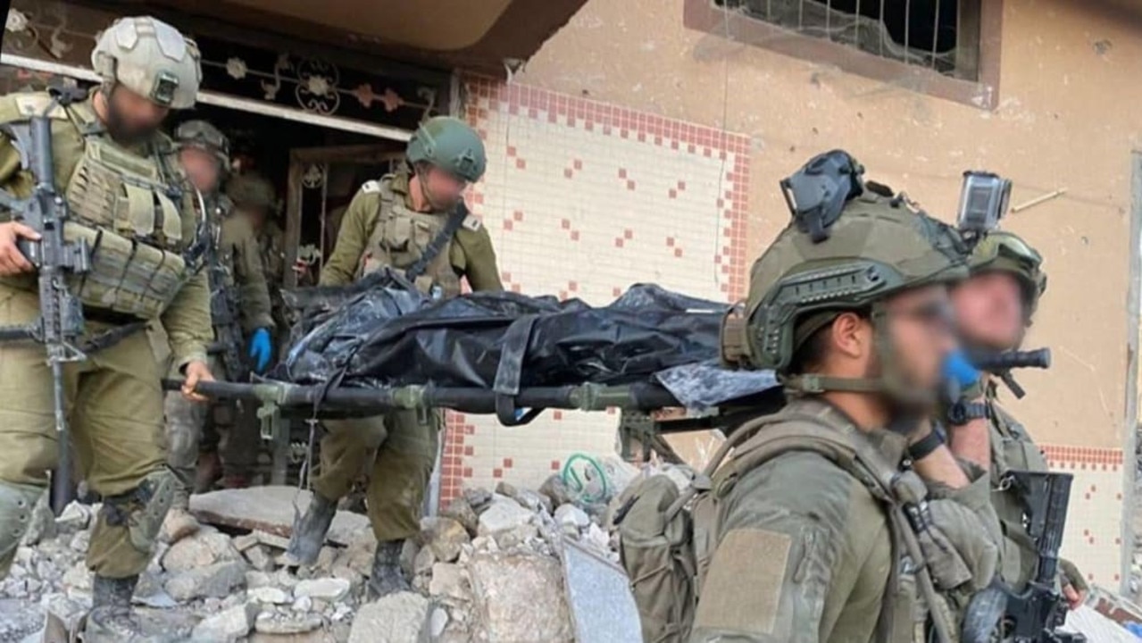 IDF soldiers carry the body of a man believed to be Sinwar on a stretcher en route to Israel from Gaza. Picture: Supplied