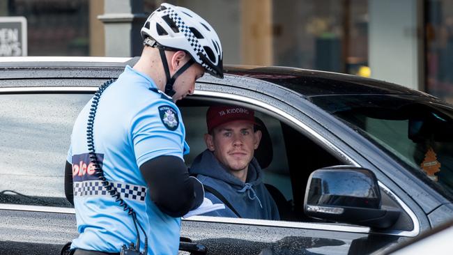 Collingwood's Ben Crocker is booked for driving while using his mobile phone. Picture: Jake Nowakowski