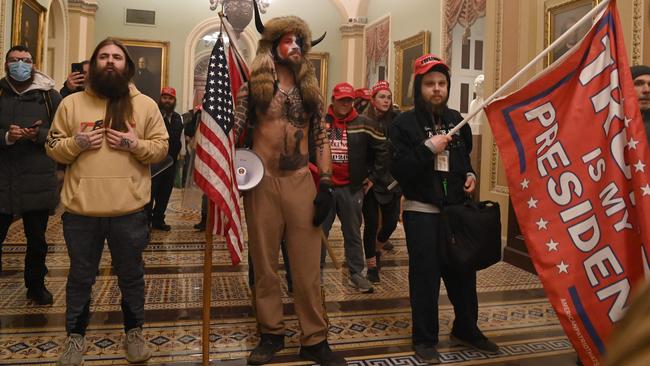 Supporters of then US president Donald Trump, including member of the QAnon conspiracy group Jake Angeli, aka Yellowstone Wolf, centre, enter the US Capitol in Washington on January 6 last year. Picture: AFP