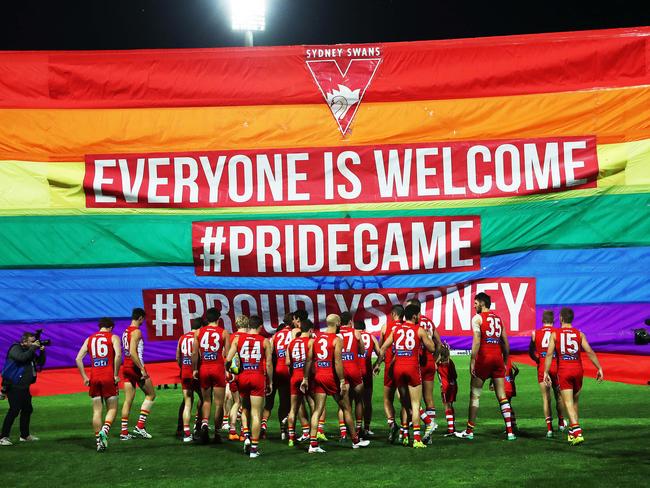 The Swans running through a Pride Game banner. Picture. Phil Hillyard