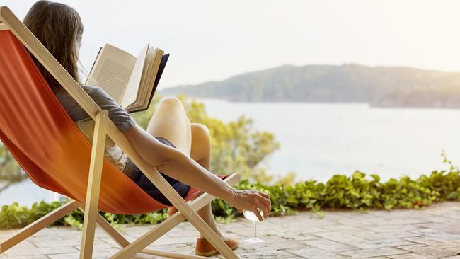 Woman reading book while relaxing on deck chair at back yardESCAPEAUGUST 30 2020NEWS & VIEWS OPINION