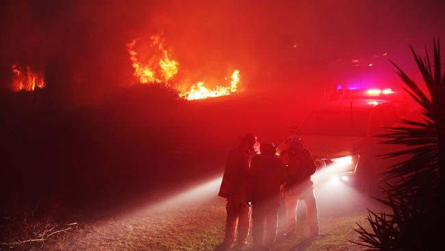 Firefighters on the scene of a bushfire that threatened homes along Palm Meadows Drive and the Boonaroo Park area. Picture: Glenn Hampson.