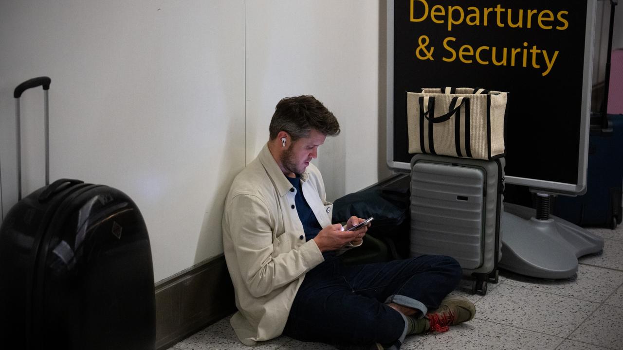 A man checks his phone as he waits at Gatwick Airport on August 28, 2023 in Crawley, United Kingdom. Picture: Carl Court/Getty Images.