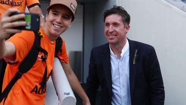 Incoming Brisbane head coach Robbie Fowler poses with a fan before the Roar's match against Adelaide at Suncorp Stadium. Picture: Getty Images