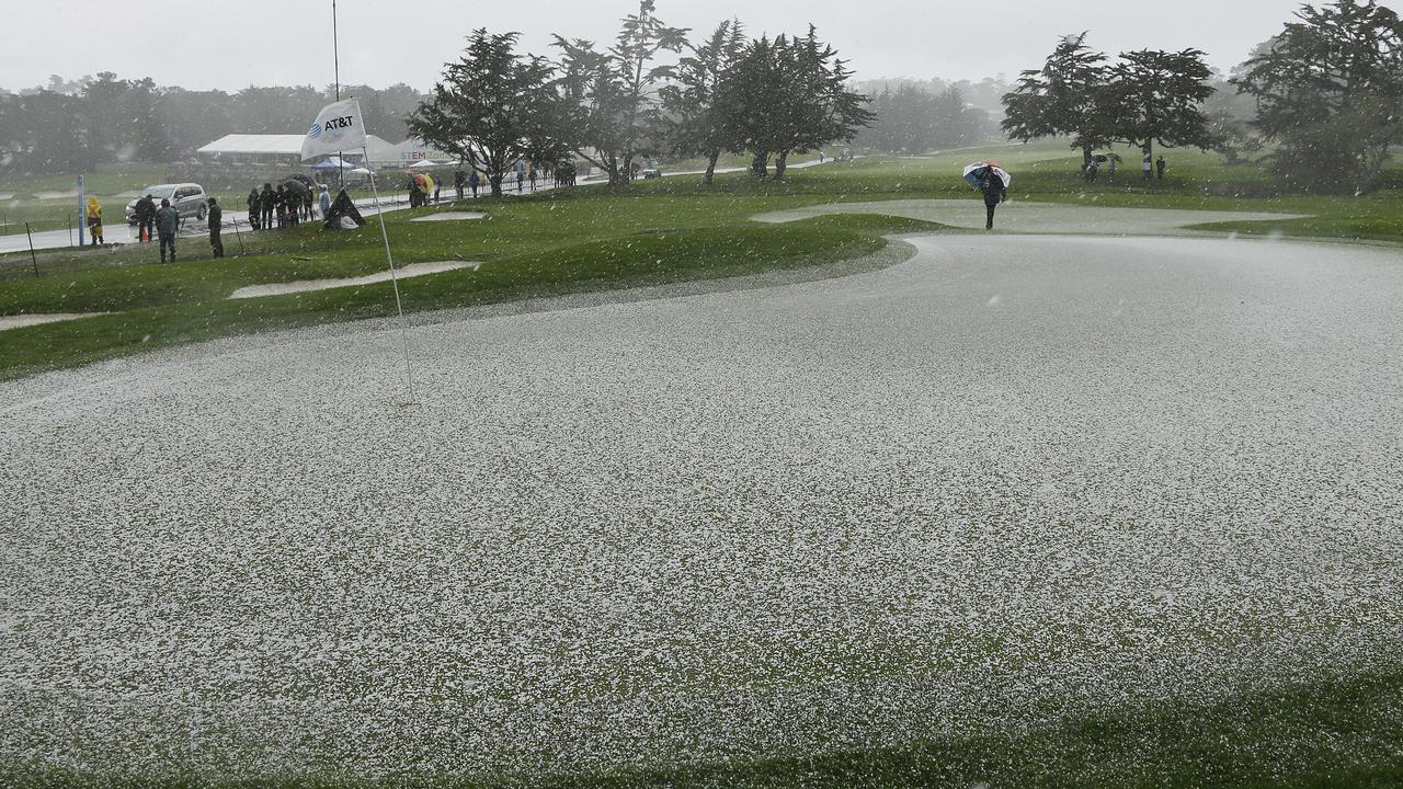 Hail covers the second green of the Pebble Beach Golf Links. Play was suspended on the final day due to a freak storm. (AP Photo/Eric Risberg)
