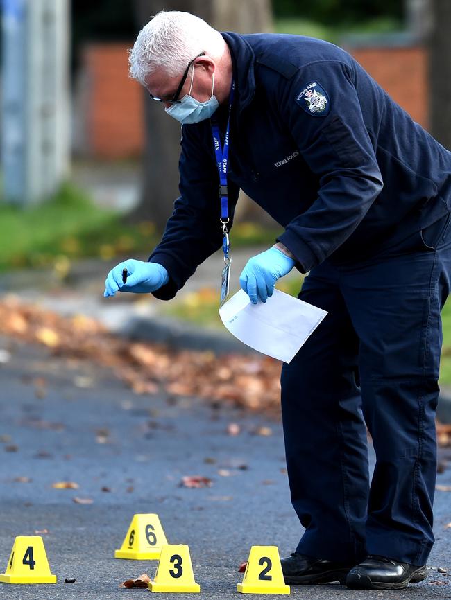 A forensic officer investigates the shooting. Picture: Nicole Garmston