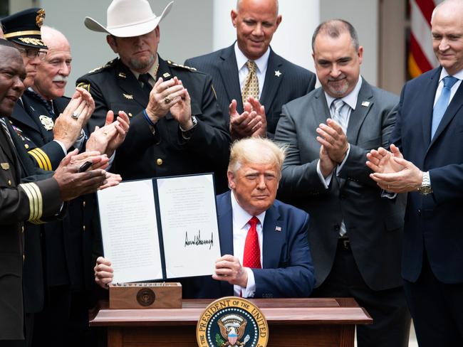 US President Donald Trump shows his signature on an Executive Order on Safe Policing. Picture: AFP