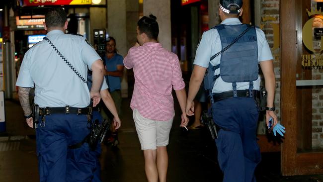 A man is lead away by police after reports of an assault at The Ivy nightclub earlier this year.