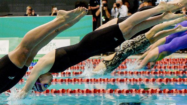 Mollie O'Callaghan (second and left, competes in a women's 50m freestyle. (Photo by Brenton EDWARDS / AFP)