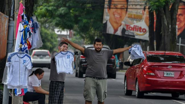 Vendors sell jerseys of the Honduran national football team in the streets of San Pedro Sula,