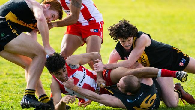 Tempers boil over between North Adelaide’s Keanu Miller and Glenelg’s, from left, Toby Pink, Alex Martini and Lewis Rayson at the Bay on Sunday. Picture: Morgan Sette