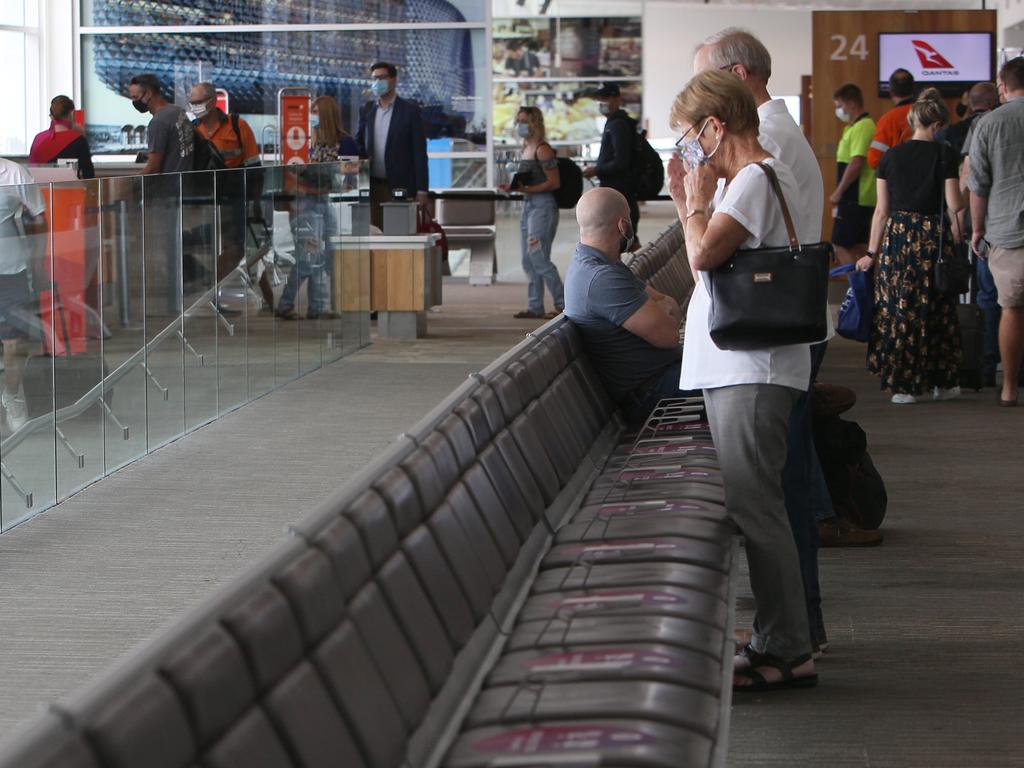 Mary and Kevin Smith farewell their daughter Leanne as she boards a flight departing Adelaide to Perth. Picture: Emma Brasier