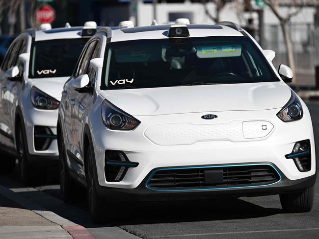 Vay remote driving Kia electric vehicles sit parked ahead of the Consumer Electronics Show (CES) in Las Vegas, Nevada on January 6, 2025. Over the last year, consumers in Las Vegas have been able to test drive Vay, one of a number of emerging players aiming to disrupt road transport with driverless mobility. On a cosmetic level, Vay's service resembles autonomous robotaxis, where a customer orders up a ride on a smartphone and is picked up, driven and dropped off by a vehicle with no visible driver. (Photo by Patrick T. Fallon / AFP)