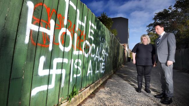 Cafe owner Aliza Shuvaly and Dvir Abramovich at a fence with an anti-Semitic message in southeast Melbourne this month. Picture: Tony Gough