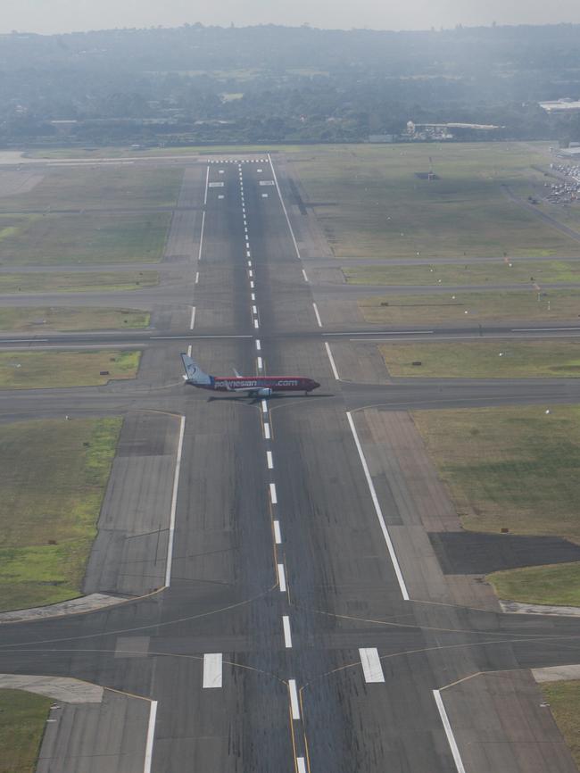 A Sydney Airport runway on a smoggy day.