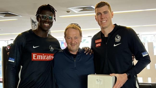 Collingwood international rookie Bassirou Faye, optometrist John Carbury and Magpie Mason Cox pictured at Collingwood with their prescription glasses.