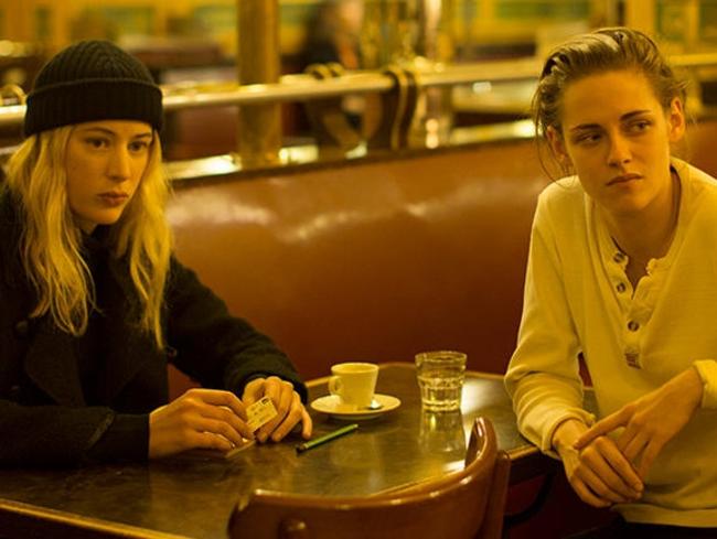 Sigrid Bouaziz and Kristen Stewart swap notes in a Parisian cafe.