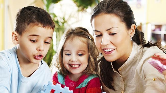 Nursery teacher playing with the kids.