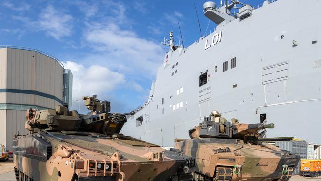 Australian Army Infantry Fighting Vehicles, Hanwha Defense Australia Redback(left) and the Rheinmetall Defence Australia KF-41 Lynx, stand ready to board HMAS Adelaide at HMAS Kuttabul, NSW. *** Local Caption *** The choice between Hanwha's Redback and Rheinmetall's KF41 Lynx represents the biggest acquistion in Army's history, costed at up to $27.1 billion. Sea transportability trials come at the end of two years of extensive field user testing of the two vehicles, with a recommendation to go to government for a decision next year.