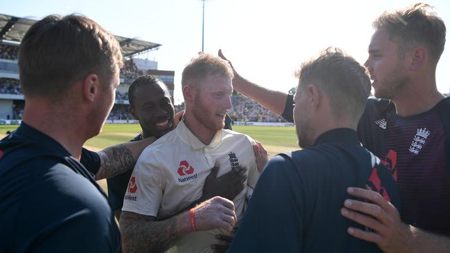 The English players rush to congratulate Ben Stokes after his heroics.