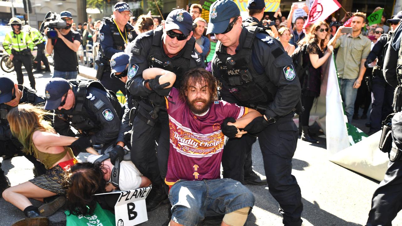 Police arrest Extinction Rebellion protesters after they blocked a major intersection in Brisbane. Picture: AAP