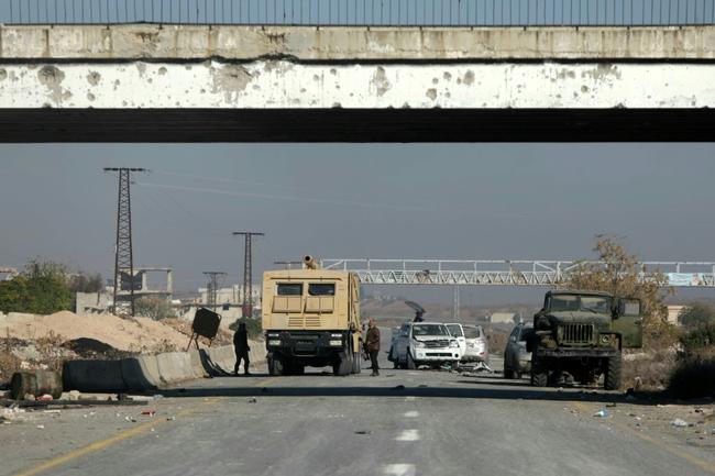 Syrian army military vehicles are abandoned on a highway in Morek, northwest of Syria's fourth-largest city of Hama