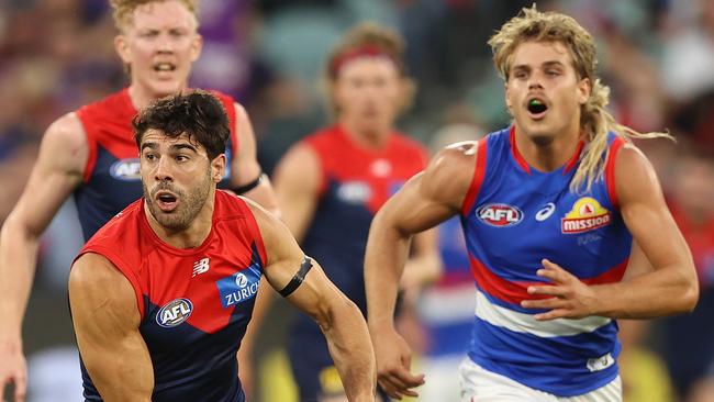 MELBOURNE, AUSTRALIA - MARCH 16: Christian Petracca of the Demons runs with the ball during the round one AFL match between the Melbourne Demons and the Western Bulldogs at the Melbourne Cricket Ground on March 16, 2022 in Melbourne, Australia. (Photo by Robert Cianflone/Getty Images)