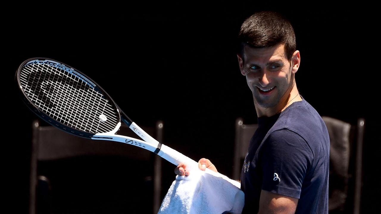 Novak Djokovic of Serbia smiles during a practice session ahead of the Australian Open at the Melbourne Park tennis centre in Melbourne on January 12, 2022. (Photo by William WEST / AFP) / -- IMAGE RESTRICTED TO EDITORIAL USE - STRICTLY NO COMMERCIAL USE --
