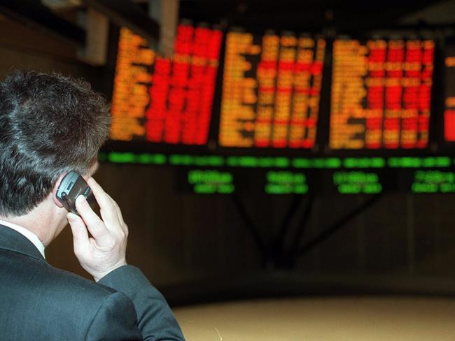 Private dealer Geoff Ballard talking on mobile phone looking at stock board at the Australian Stock Exchange 18 Aug 1997. sharemarket graphs generic ASX