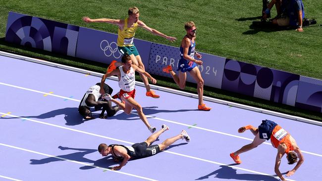 Stewart McSweyn (top) leaps to avoid a pile of runners, including Great Britain’s George Mills (centre bottom). (Photo by Patrick Smith/Getty Images)