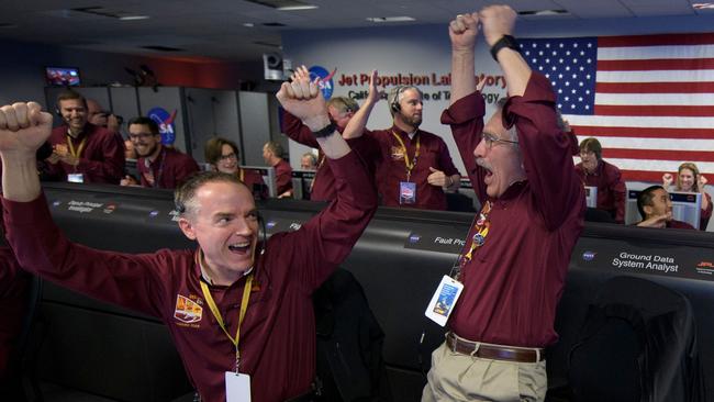 Team members Kris Bruvold (L) and Sandy Krasner react after receiving confirmation that the Mars InSight lander successfully touched down on the surface of Mars. Picture: NASA/AFP