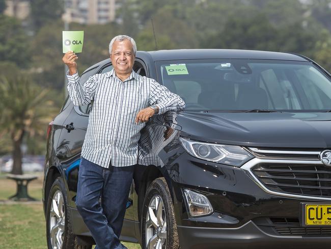 EXPRESS ADVOCATE/AAP. Ola driver Lindsay Aristobil-Adele poses for a photograph with his car at Gosford on Friday, 24 January, 2020. New ride sharing company Ola is launching on the Central Coast. (AAP IMAGE / Troy Snook)