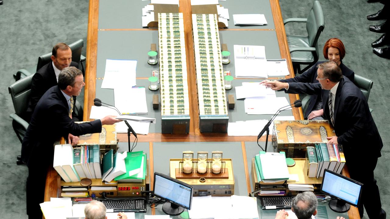 Then prime minister Julia Gillard and opposition leader Tony Abbott watch as the manager of opposition business Chris Pyne and leader of the House Anthony Albanese argue in 2012. Picture: Alan Porritt/AAP