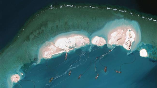 Satellite images show what is believed to be Chinese vessels dredging sand at Mischief Reef in the Spratly Islands. Picture: Getty Images