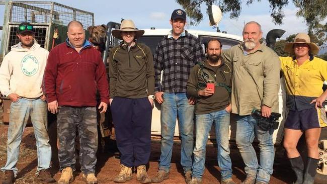 Greig Tonkins, centre in checked shirt, reacted to his dog in a headlock by hitting the roo.