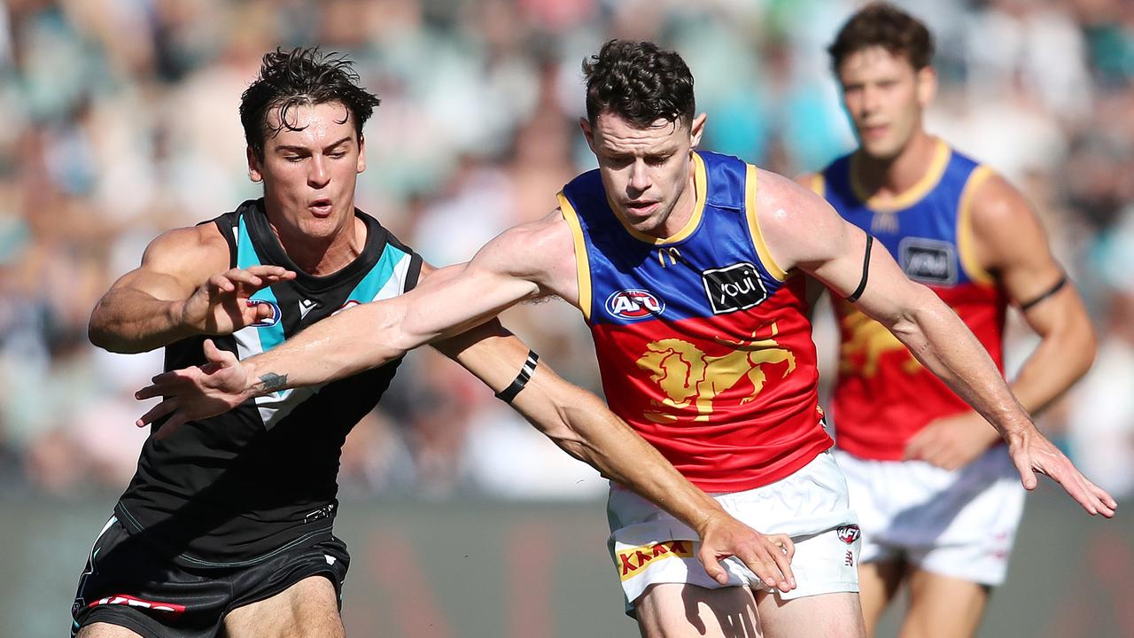 Connor Rozee fights for the footy with Lachie Neale. Picture: Sarah Reed/AFL Photos via Getty Images