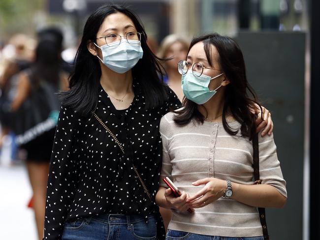 Two women walk in Sydney’s CBD wearing face masks as the fear of the deadly coronavirus spreads. Picture: Sam Ruttyn