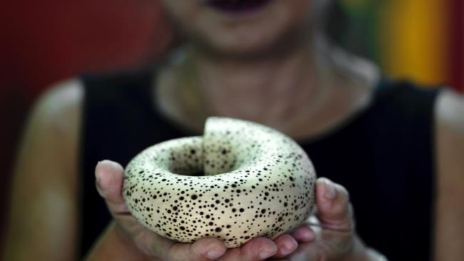 Lee holds a model of her sculpture Ouroboros. Picture: Justine Walpole