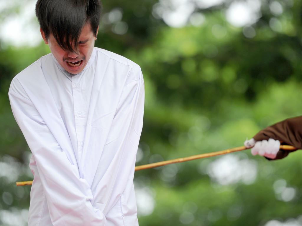 A man is caned for breaking sharia rules in Indonesia’s conservative Aceh province where homosexuality is banned. There are fears new laws could effectively outlaw it everywhere. Picture: Chaideer Mahyuddin/AFP