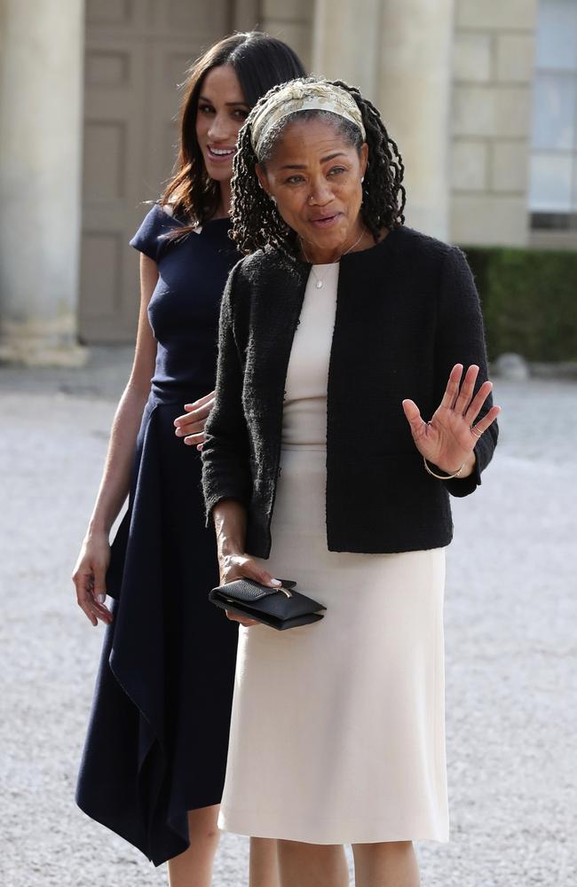 The yoga teacher and social worker practices her royal wave after enjoying afternoon tea with her daughter, Prince Harry, the Queen and the Duke of Edinburgh. Picture: Steve Parsons/Pool Photo via AP