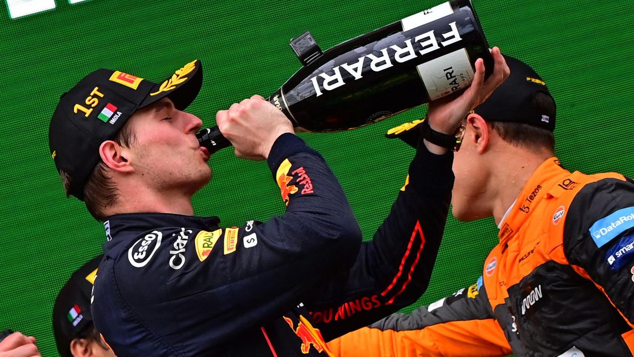 Max Verstappen drinks from a bottle of champagne. Photo by ANDREJ ISAKOVIC / AFP.