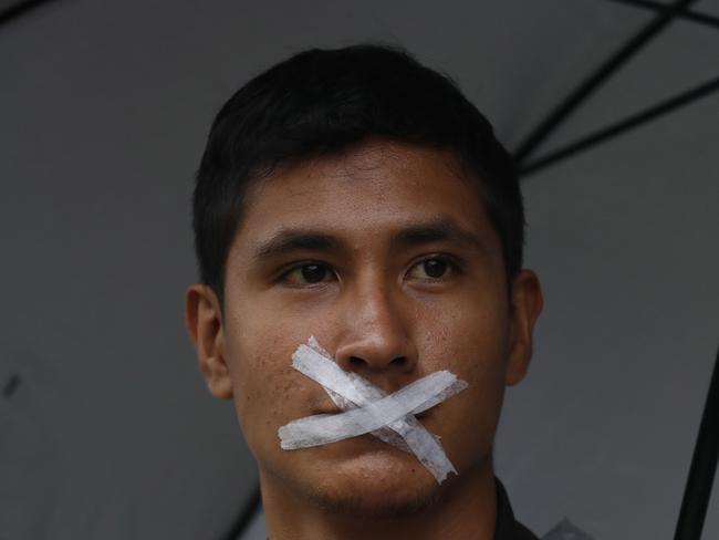 A student with his mouth taped shut participates in the march of silence, along with thousands of other students in protest against groups of institutional thugs that operate on campus at Mexicoâ€™s National Autonomous University, UNAM, in Mexico City, Thursday, Sept. 13, 2018. The students are demanding an end to violence by groups of thugs known as â€œporrosâ€ who are often registered but donâ€™t attend classes. (AP Photo/Marco Ugarte)