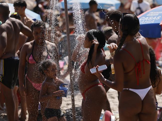 RIO DE JANEIRO, BRAZIL - NOVEMBER 15: Girls take a shower at the beach amid a record-breaking heat wave at Ipanema beach on November 15, 2023 in Rio de Janeiro, Brazil. On the proclamation of the Republic holiday temperature spiked over 42ÃÂ°C (107.6 fahrenheit) as thermal sensation rose to 58.5ÃÂ°C (137.3 fahrenheit).  (Photo by Wagner Meier/Getty Images)