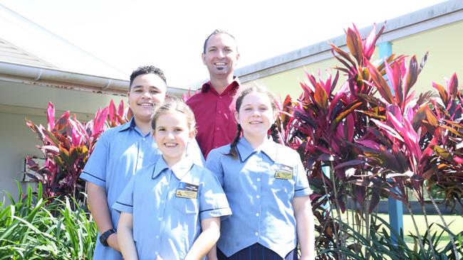 Cairns Adventist College students Evander Paletua, McKenna Coe and Milly Suchanek with principal Adam Coe, look forward to the construction of the school's year 7 building, as it transitions into a Prep to year 12 education facility. Picture: Catherine Duffy