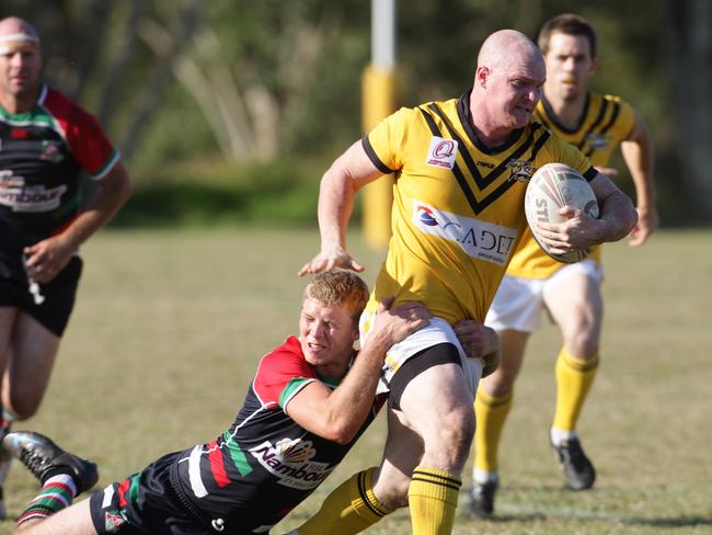 Nambour's Dale Mitchell does his best to stop Caloundra's Regan Pratten. Photo: Jason Dougherty