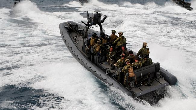 Australian Defence Force rigid-hull inflatable boats from Tactical Assault Group (East), prepare to intercept a 'suspect' vessel in the waters off Yeppoon, Queensland, during Exercise Talisman Saber 2013. *** Local Caption *** Special forces from Australia’s Tactical Assault Group (East) and the U.S. Marine Corps, conducted a joint seaborne and airborne boarding of a ship underway in the waters off Yeppoon as part of Exercise Talisman Saber 2013. Special forces rigid-hull inflatable boats (RHIBs) successfully boarded a small team to secure an area of the ship before further teams boarded from RHIBs and others fast-roped onto the deck from Australian Army Black Hawk helicopters. The special forces took control of the suspect vessel, engaged the ‘enemy’ and conducted a thorough search before being winched back onboard the Black Hawks and returning to base. Royal Australian Navy refuelling tanker HMAS Sirius acted as the ‘suspect’ vessel during the exercise scenario. The ADF has two Tactical Assault Groups – East (Sydney) and West (Perth) – tasked with direct action counter-terrorism and hostage recovery. Tactical Assault Group (East) is comprised of Australian Army soldiers from 2nd Commando Regiment, Special Operations Engineer Regiment, Special Operations Logistics Squadron and Royal Australian Navy clearance divers. Exercise Talisman Saber (15 July – 5 August 2013) is a major bilateral exercise designed to improve training and interoperability between Australian and United States military forces and other government agencies. Around 28,000 Australian and US personnel are taking part in the 21-day exercise, currently being conducted in the Coral Sea and military training areas in central and northern Queensland. Supporting activities are underway in the waters of the Timor and Arafura Seas, and throughout Queensland and the Northern Territory.